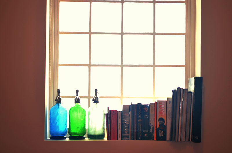 Old Water Siphons Books Against Brick Glass