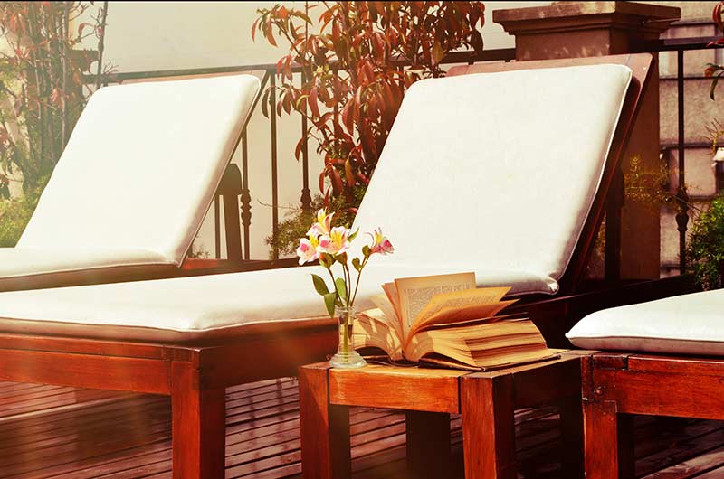 Three Lounge Chairs White Cushions Book Flower